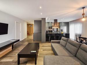 a living room with a couch and a table at Ocean Breeze - Comfortable Ap Close to the Beach in Bicas