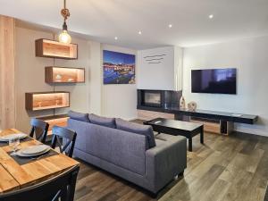 a living room with a couch and a table at Ocean Breeze - Comfortable Ap Close to the Beach in Bicas