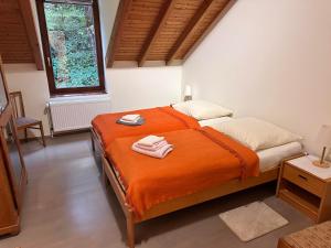 a bedroom with a bed with two towels on it at Neumühle Saar in Mettlach