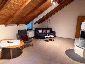 a living room with a couch and a table at Neumühle Saar in Mettlach