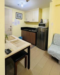 a small kitchen with a stainless steel refrigerator at Henry's Newport Condotel in Manila