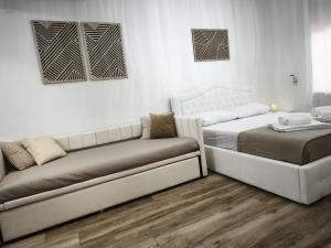 a living room with two beds and a couch at B&B Ampelea in Gallipoli +16 photos