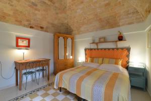 a bedroom with a bed and a table with a night stand at Da Ida - Matera Cento Storico - Sassi in Matera