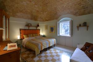 a bedroom with a bed and a window at Da Ida - Matera Cento Storico - Sassi in Matera