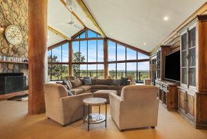 a living room with a couch and a tv at The Lodge at Eagle Rock Farm, in Mandemar