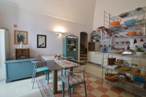 a kitchen with a table and chairs and shelves at Da Ida - In Lak' Ech in Matera