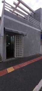 a building with a window with awning on it at Kitnet próximo ao shopping in Campo Grande