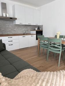 a kitchen with a couch and a table and chairs at LA CASETTA - Clusone in Clusone +12 photos