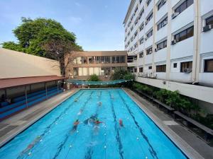 a large swimming pool in front of a building at YMCA of Manila Hostel in Sampong