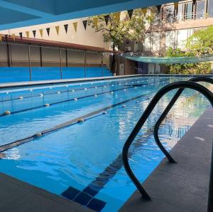 a swimming pool with blue water in a building at YMCA of Manila Hostel in Sampong +20 photos