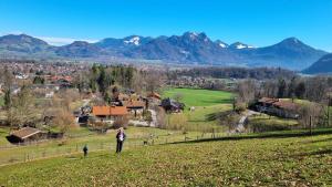 a person standing on a hill looking at a village at Endorfer Stubn in Bad Endorf
