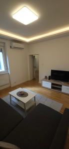 a living room with a couch and a coffee table at Apartment Green Lux in Belgrade