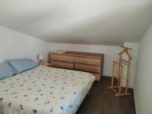 a bedroom with a bed and a wooden dresser at Villa Nausicaa in Hyères +16 photos