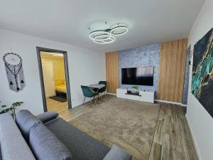 a living room with a couch and a flat screen tv at Casa Darius 1 in Alexandria