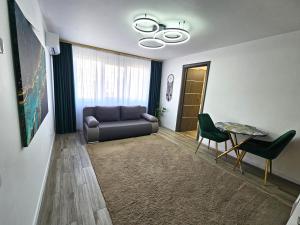 a living room with a couch and a table at Casa Darius 1 in Alexandria