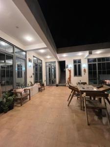 a large room with wooden tables and windows at The Peace Corgaon in Corgao