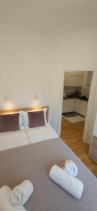 a bedroom with a bed with two towels on it at Apartment Green Lux in Belgrade