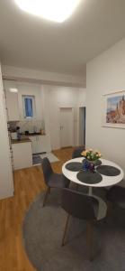 a living room with a table and some chairs at Apartment Green Lux in Belgrade