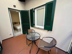 a room with two chairs and a table and a window at White Suite Lakeside in Colonno
