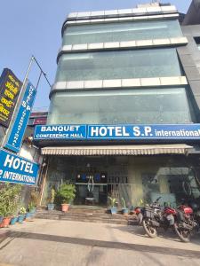a hotel with a motorcycle parked in front of it at Hotel SP international Lucknow in Lucknow