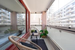 a balcony with two chairs and a table at Spacious Downtown Apt with Balcony - Hosts 10 in Tampere