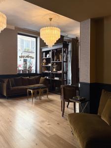 a living room with a couch and a table at New Hotel République in Paris