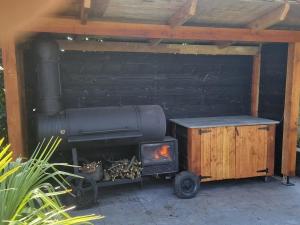 a outdoor grill with a stove and a smoker at Vacation on the farm in Lanaken