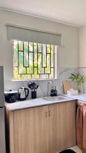 a kitchen with a sink and a stained glass window at The HappyNest Tagum in Tagum