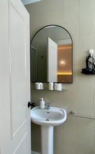 a bathroom with a sink and a mirror at BOHEMIA SANLUCAR in Sanlúcar de Barrameda +51 photos