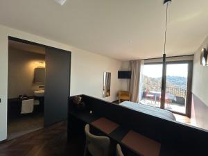 a bedroom with a bed and a view of a bathroom at El Cielo - Rooms with Panoramic View & El Carnicero Restaurant in Cornedo Vicentino