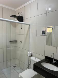 a white bathroom with a toilet and a sink at HOTEL SAYMON - Cafelândia PARANÁ in Cafelândia +19 photos