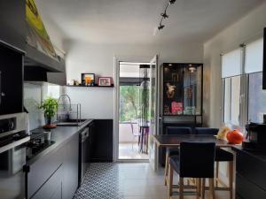 a kitchen with a table and a dining room at UN OASIS EN PROVENCE in Aubagne