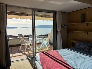 a bedroom with a bed and a view of the ocean at The Lookout in Ghiffa