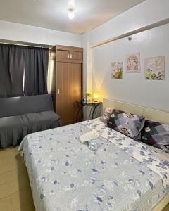 a bedroom with a bed and a couch in it at Henry's Newport Condotel in Manila +61 photos