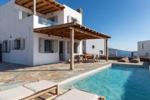 a villa with a swimming pool and a house at West Side Pool House by Hostandros in Gavrio
