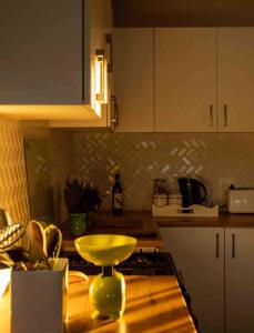 a kitchen with a counter top with a yellow bowl on a table at Lake Zonk Cottage in Mooiriver +22 photos