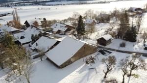 an aerial view of a house covered in snow at Ferme en pleine nature in Boudevilliers