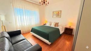 a living room with a bed and a couch at 威尼斯Mestre火车站明亮舒适便捷整套公寓Casa Marco in Marghera
