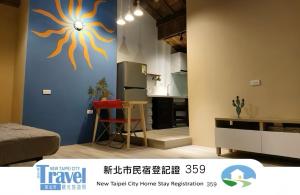 a kitchen with a blue wall with a sun painted on it at Shan Cheng Guesthouse in Ruifang