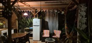 a white refrigerator in a room with some plants at LEFOUXIOL in La Trinité