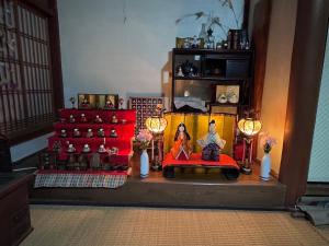 a figurine of a couple sitting on a couch in a room at 棚田ハウス in Murai