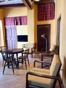 a living room with tables and chairs and a couch at Utu house in Zanzibar City