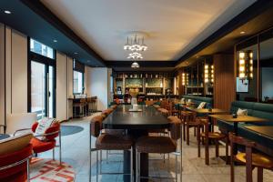 a restaurant with tables and chairs and a bar at Hotel Le Lumière in Lyon