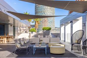 a patio with chairs and tables on a building at Hotel SB Glow 4 Sup in Barcelona