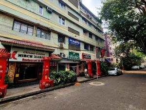 a building on a city street with signs on it at Park Palace Hotel in Kolkata