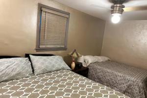 a bedroom with two beds and a window at Economy 3 beds in Moorhead
