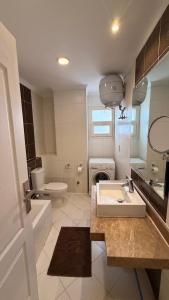 a bathroom with a sink and a toilet at Dream Royal Residence in 6th Of October +118 photos