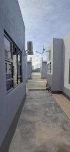 an empty hallway of a building with a window at Florino GuestHouse in Rundu