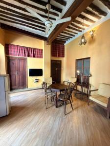 a living room with a table and chairs and a television at Utu house in Zanzibar City