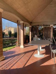 a patio with a table and chairs on it at Casa Rustica - Camere in Torri di Quartesolo +8 photos